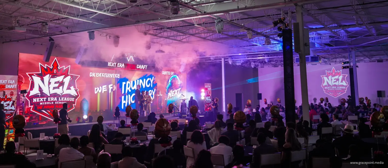 A player and family celebrating a team selection on the Draft stage